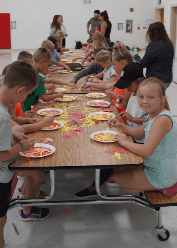 Launch Kids make paper plate pizzas
