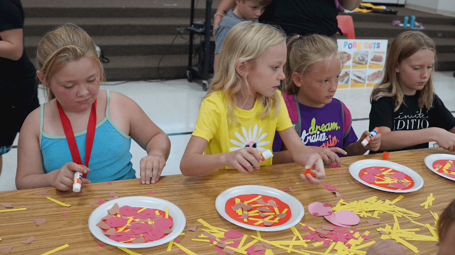 Launch Kids create pork paper plate pizzas