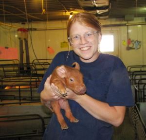 Annie Wallin holding a pig