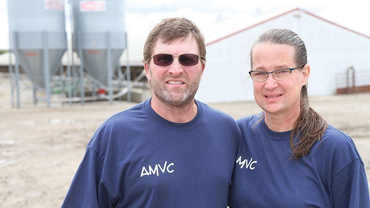 AMVC growers Mike and Tracy Marshall stand outside of their finishing swine barn