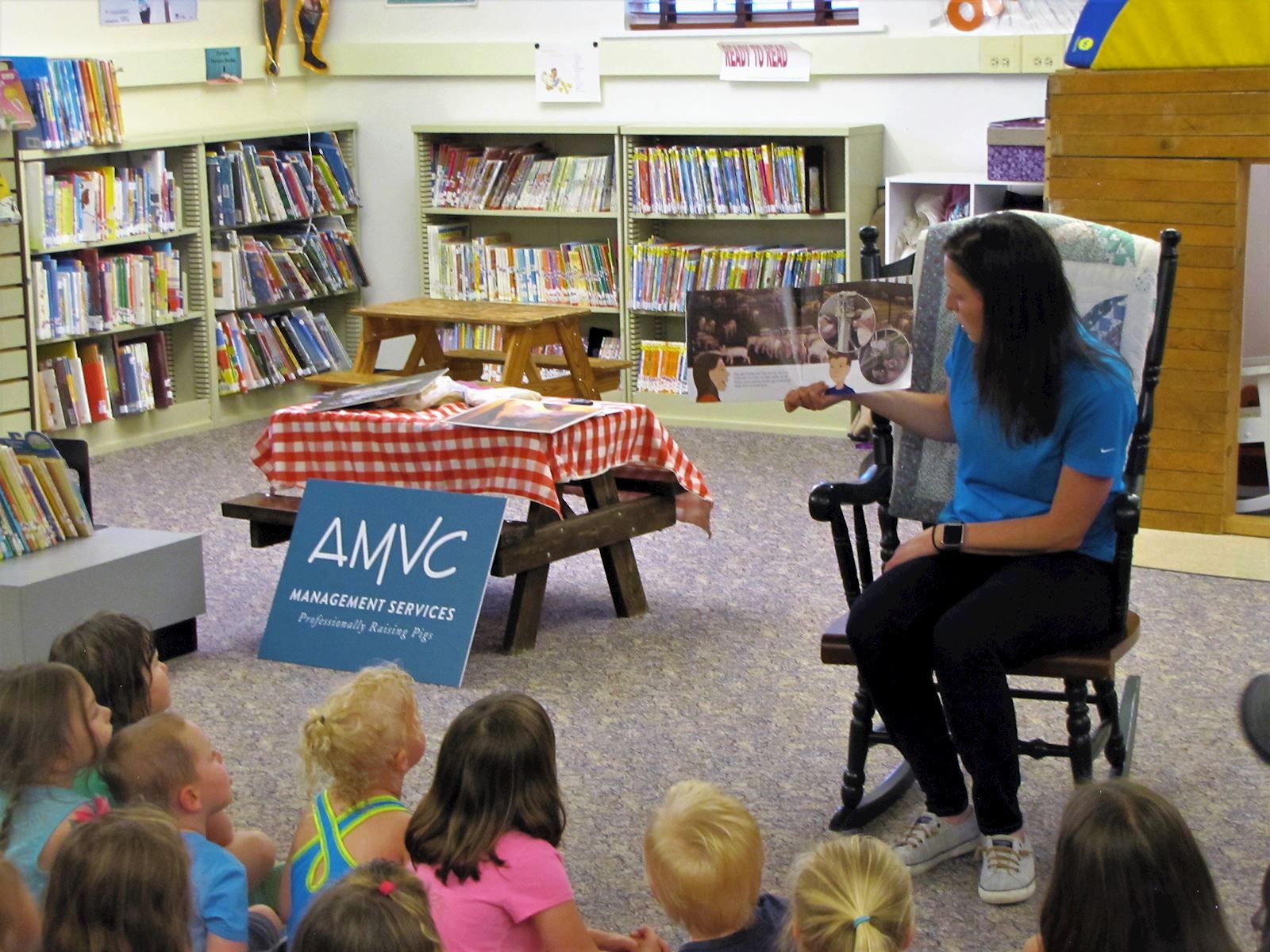 AMVC public relations coordinator, Alicia Humphrey, reads a non-fiction pig story to the group.