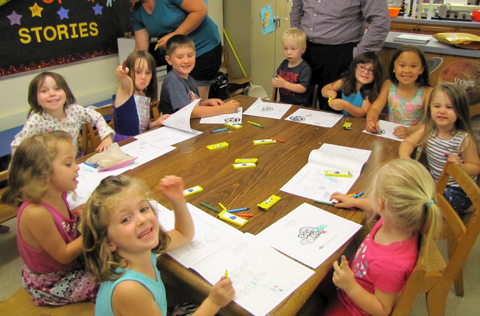 Children coloring in their "Producers, Pigs and Pork" books