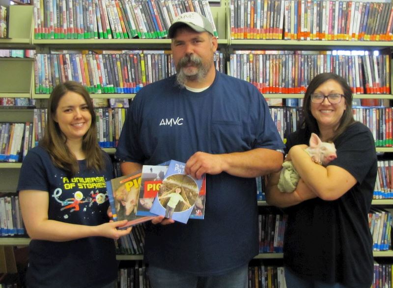 To increase agriculture literacy in the community, Gary Potts, AMVC Colfax employee, center, donates